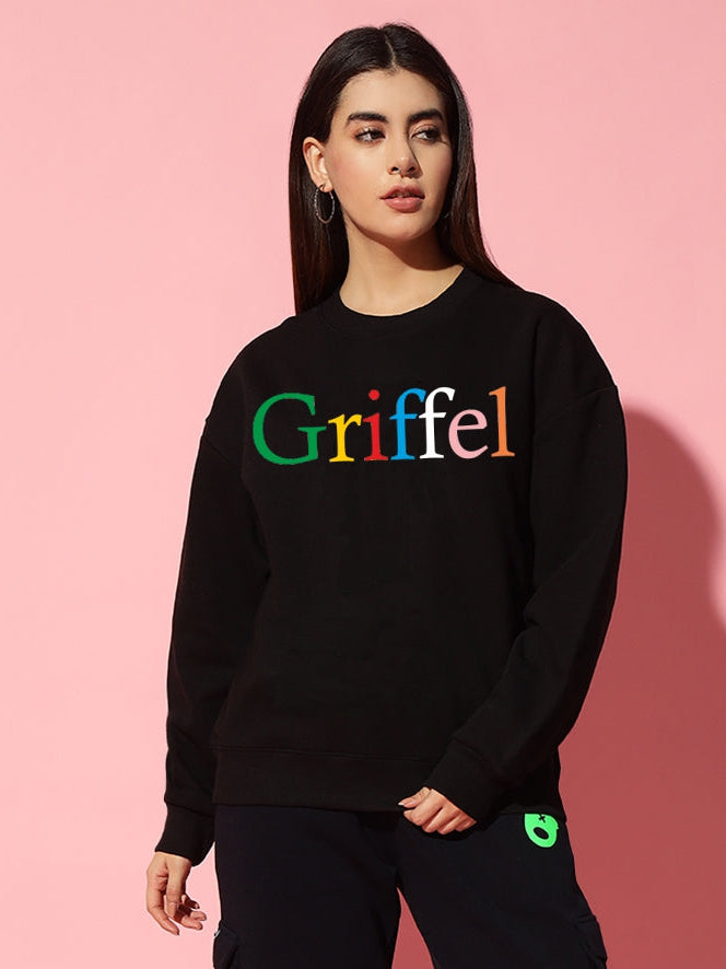 Person wearing a black outfit with 'Griffel' text on a pink background